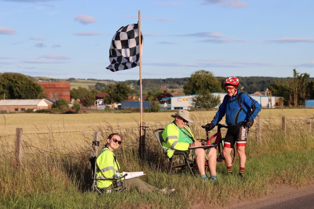 Timekeepers at the finish line at an FCA Midweek time trial event near Ladybank