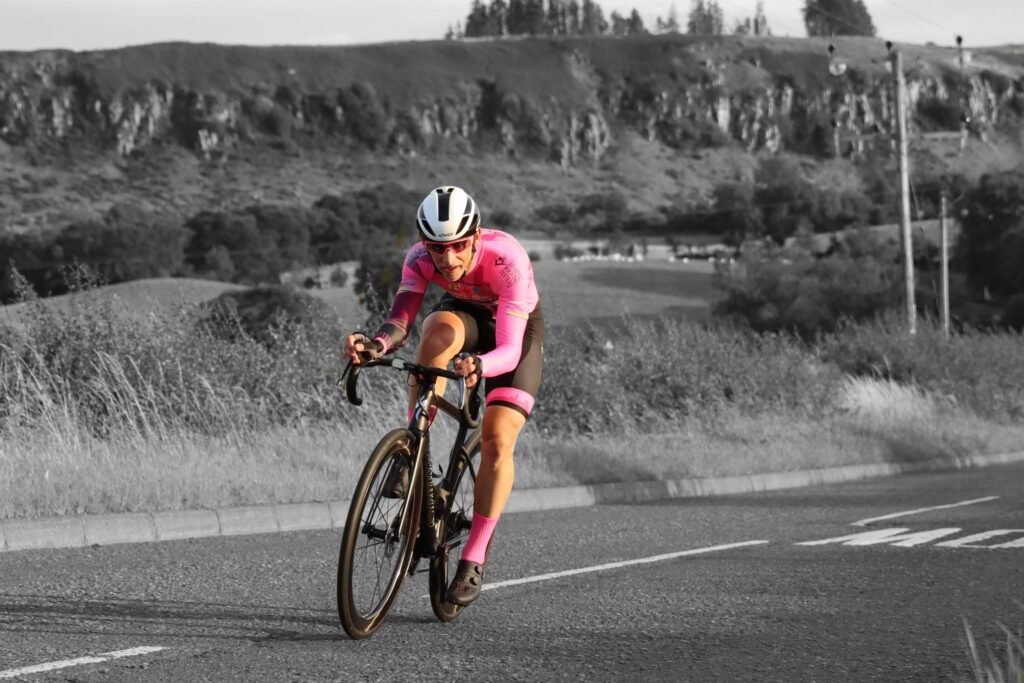 A Team Andrew Allan Architecture member racing a road bike at an FCA Midweek Time Trial event
